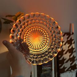 This is a pale blue pressed glass plate in the bubble pattern by Anchor Hocking