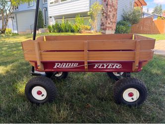 Red Radio Flyer wagon with wood sides