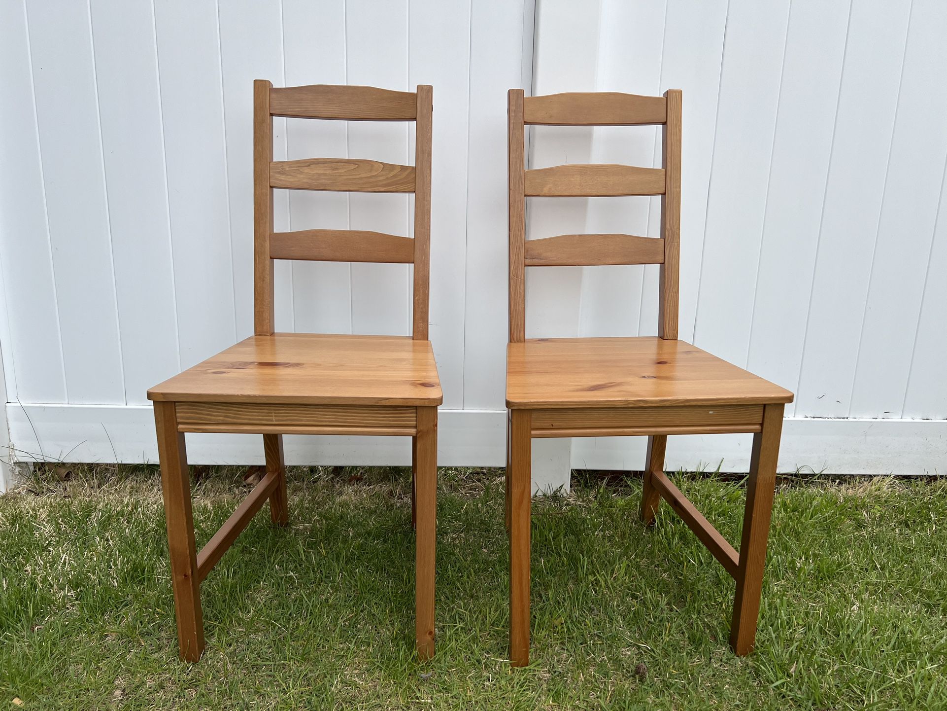 two lightweight wood dining chairs