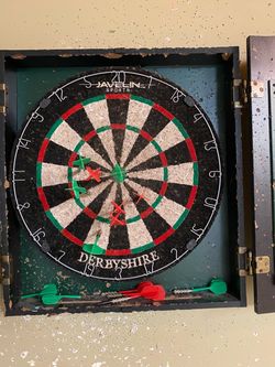 Well used dart board in case