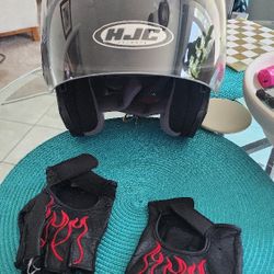 Two Motorcycle Helmet And Gloves