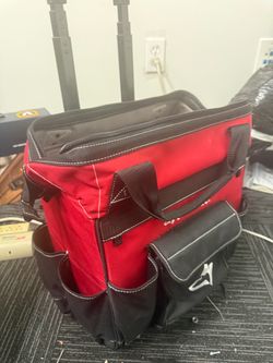 The Husky 18 in. Rolling Tool Bag features a heavy-duty telescoping handle and two wheels for easy mobility