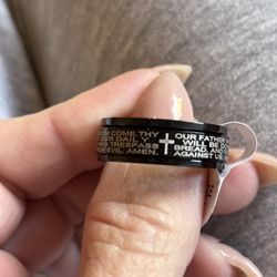 Prayer ring size 11 black with the Lord's prayer and a cross. It's also a fidget ring where the middle spins if you want to.