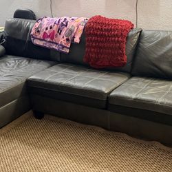 Ashley Furniture-Black faux leather Nokomis sectional sofa 