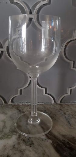 clear glass water goblet with a distinctive paneled or ribbed column stem