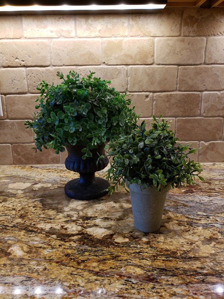 Faux plants in ceramic pots