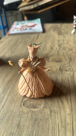 Princess figurine holding wand pink gold white