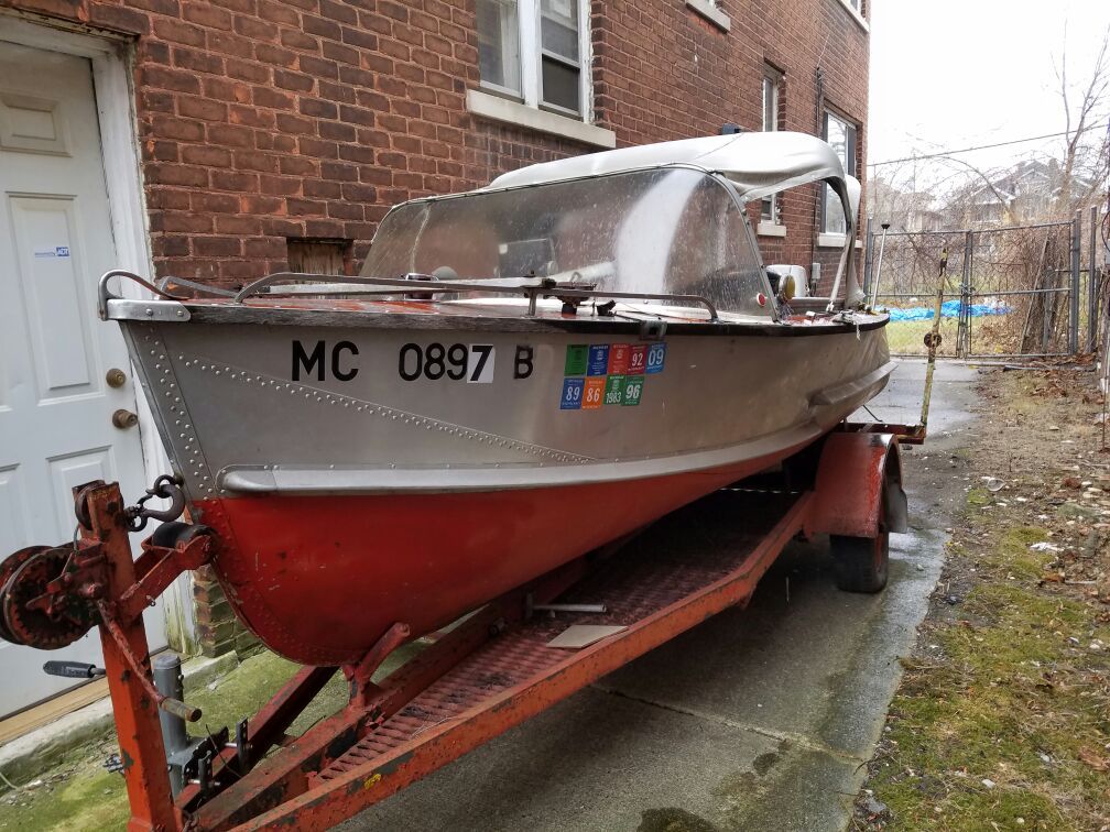 Aluminum boat with trailer and motor.