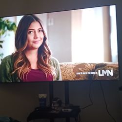 65 inch Samsung CU 7000 Model lije new along with a beautifulf  TV Stand also