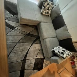 Grey Couch With Black And Gray Rug