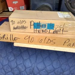 1990 98 olds Right hand headlight bezel & grille NOS.