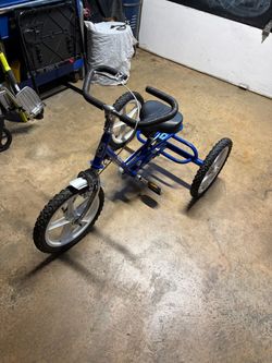 Theraplay Terrier adaptive tricycle in blue. This specialized three-wheeled bicycle is designed for children who require enhanced stability, trunk sup