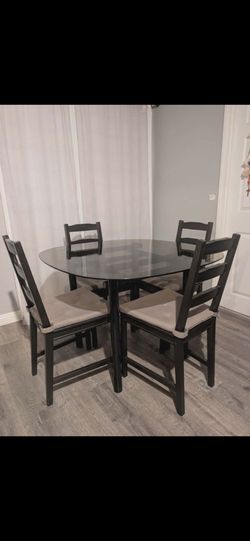 Glass dinning table and four chairs