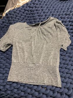 Soft gray short sleeve top with subtle silver sparkle detail and lace back.