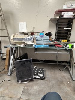 Glass office desk set up for keyboard under glass top.