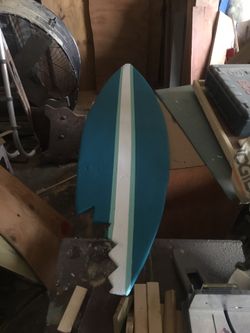 Solid wood surfboard with shark bite