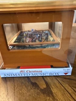 Mr. Christmas Animated Music Box. This product is a miniature, wind-up holiday decoration that plays music and features an animated scene. 
