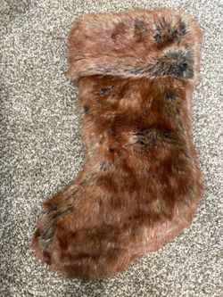 plush brown faux fur Christmas stocking featuring a soft, folded cuff.