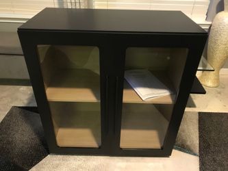 New storage cabinet with glass doors.