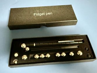 The Metal Fidget Pen Set includes a metal pen with a magnetic ball that fits inside the pen, creating a unique fidget toy for those who enjoy metal ma