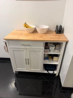 White coffee cart with light brown wood counter