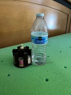 Small plastic rotating thread spool carousel caddy.