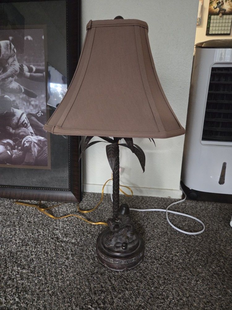 Brass Monkey Sitting Under A Tree Lamp