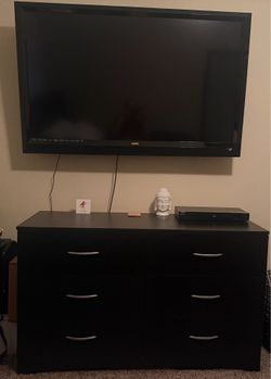 Tv with bracket to mount and dresser