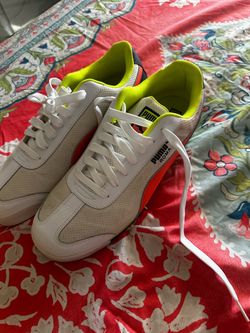 They’re PUMA Roma sneakers, white with red accents and a bright lime-green lining. Sz 10