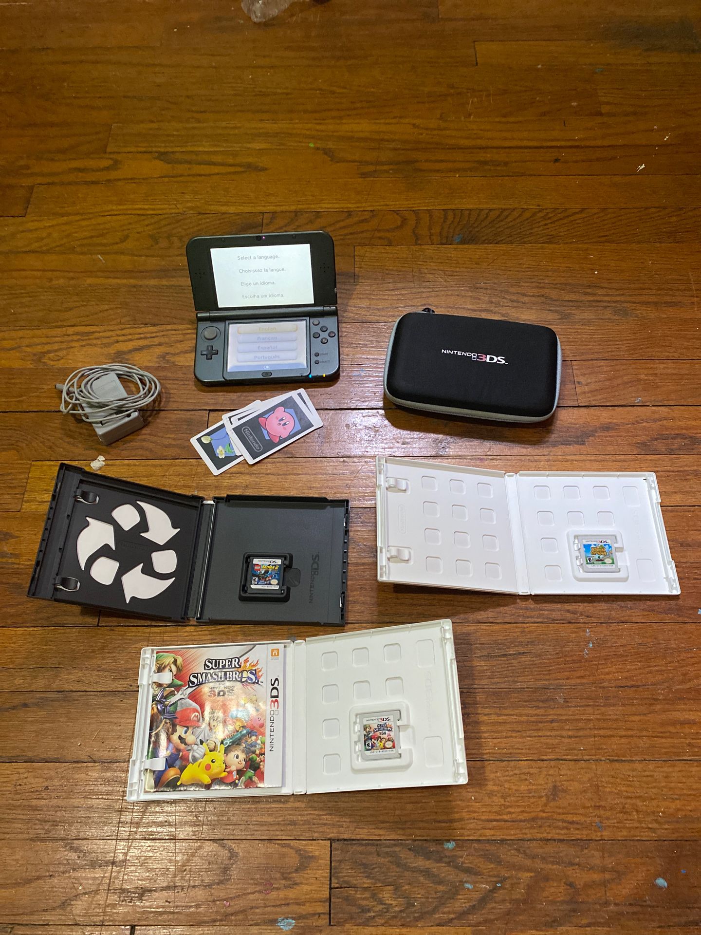 Nintendo 3DS XL with charger, case, and 3 games (LEGO Batman 2 DC super heroes, Super Smash Bros for 3DS, and lastly Animal Crossing New Leaf)