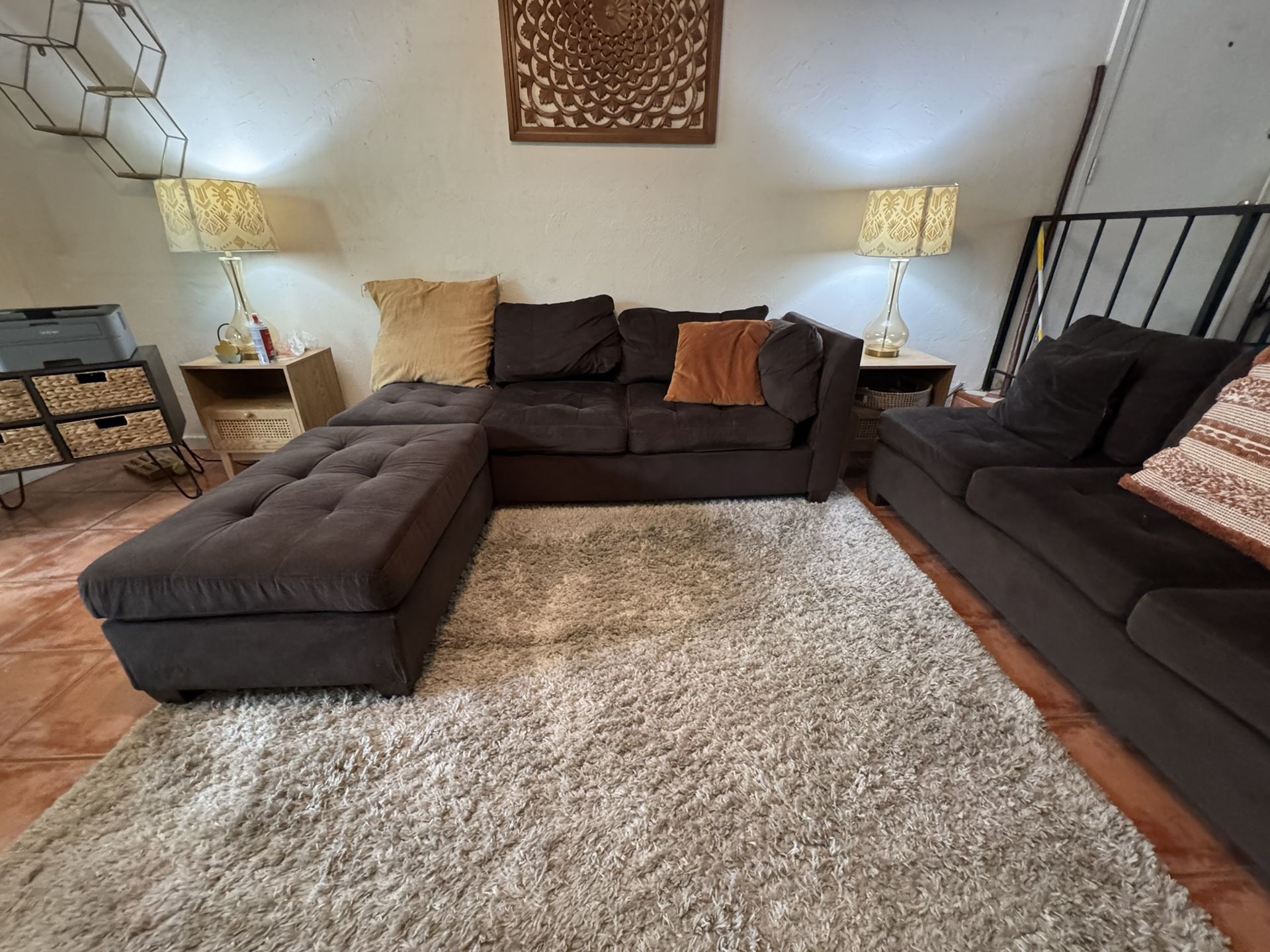 Dark brown sectional couch with Ottoman and throw pillows