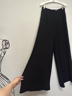Chic Black Wide-Leg Trousers high opening with under shorts.