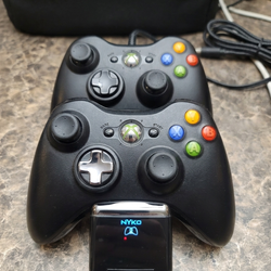 Xbox 360 Wireles Controllers with rechargeable battery packs and Nyko Dual charging stand.