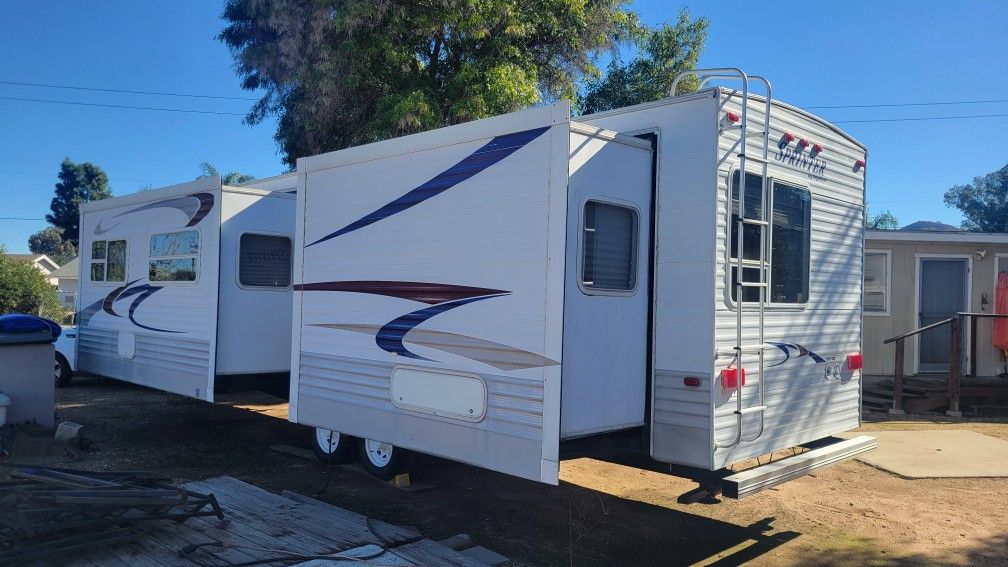 2 slide outs... bumper pull .... park model travel trailer........ large metal stairs porch