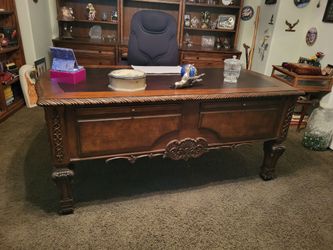 Desk large carved.Wood, perfect chair comes with it.Also, the big large cabinet behind it goes with it for your computers.And your work, it's all a se
