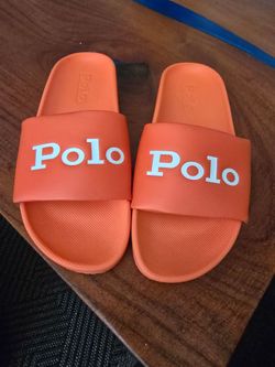 Bright and bold Polo pool slides in vibrant orange with contrasting white logo detail across the strap. Lightweight and comfortable with a cushioned t