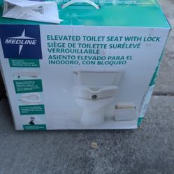 elevated toilet seat new in box. 