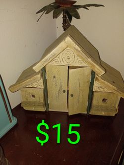 Vintage mantel clock has a teal blue plastic body with gold-toned trim. The white clock face features black Arabic numerals and ornate hands. This Elg