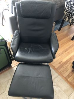Black recliner chair with foot stool