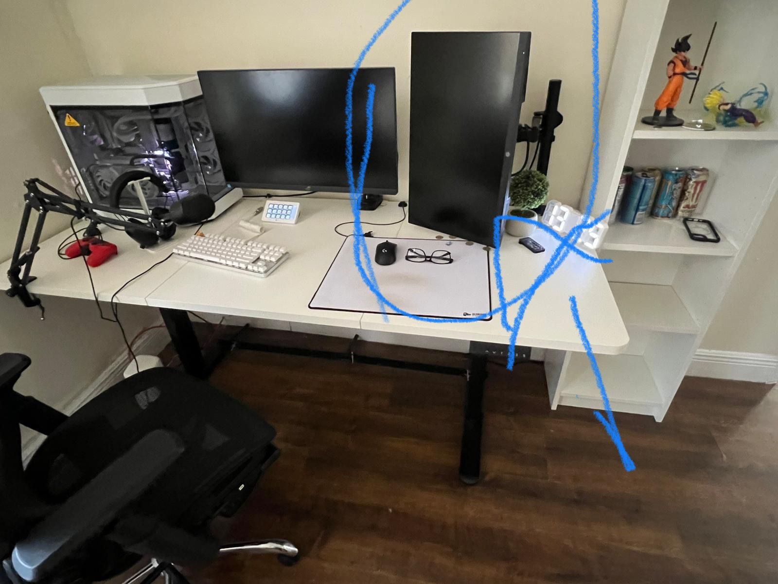 White adjustable table with a small monitor And Black Desk Chair