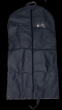 dark blue Hotel de Paris Monte-Carlo garment bag featuring a gold-embroidered crown logo