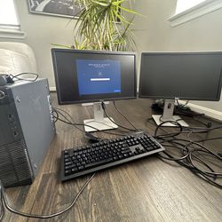 Computer Desktop And 2 Monitors With Camera And Keyboard And Mouse