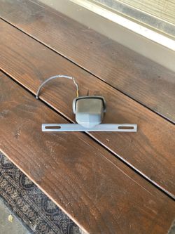 License plate holder and lamp. Think it came off in 1955 Ford Fairlane.