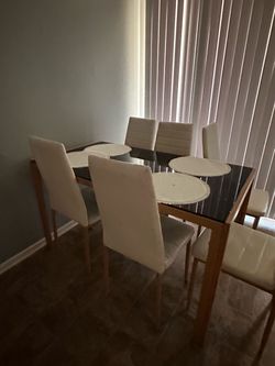 Table with 6 white chairs