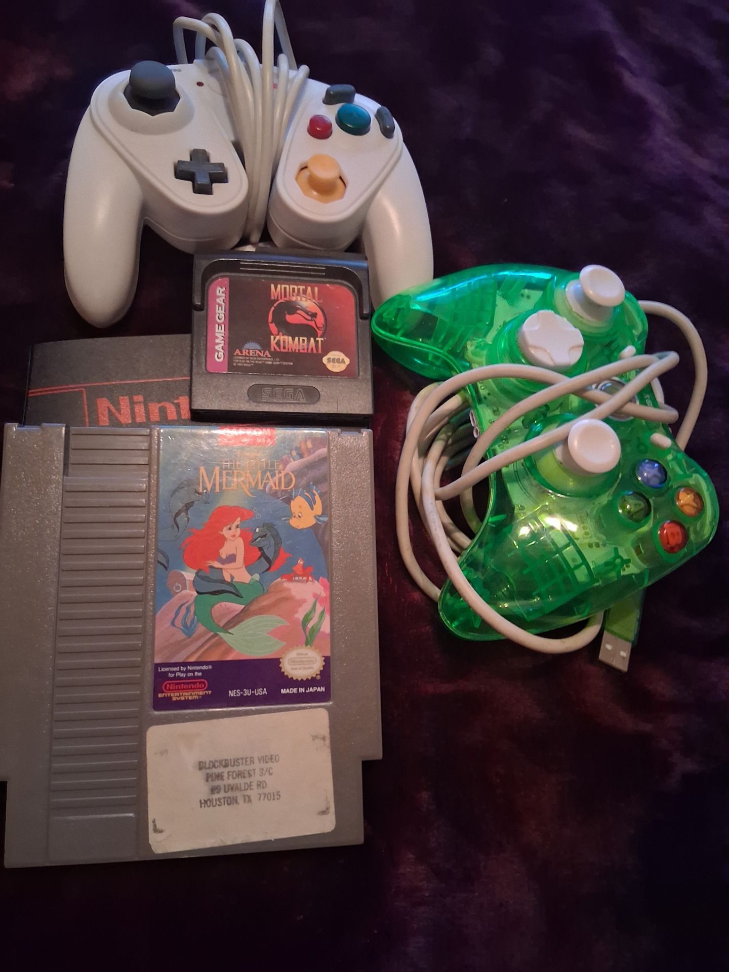 Retro game controllers 360 and GameCube/switch and original nes game and Sega gear with block buster sticker date still on