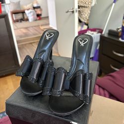 Black satin high heels with bow