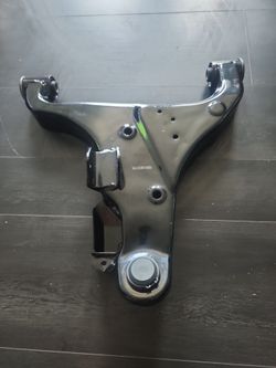black steel front lower control arm with integrated bushings and a ball joint housing,