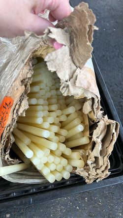 New industrial glue sticks (likely around 5/8” diameter), used in commercial glue guns