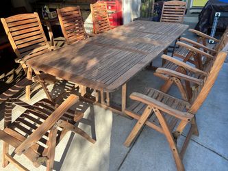 teak rectangular extending table + 8 folding teak chairs  Located in concord  Recently cleaned, sanded and teak oiled Teak wood is heavy and sturdy   