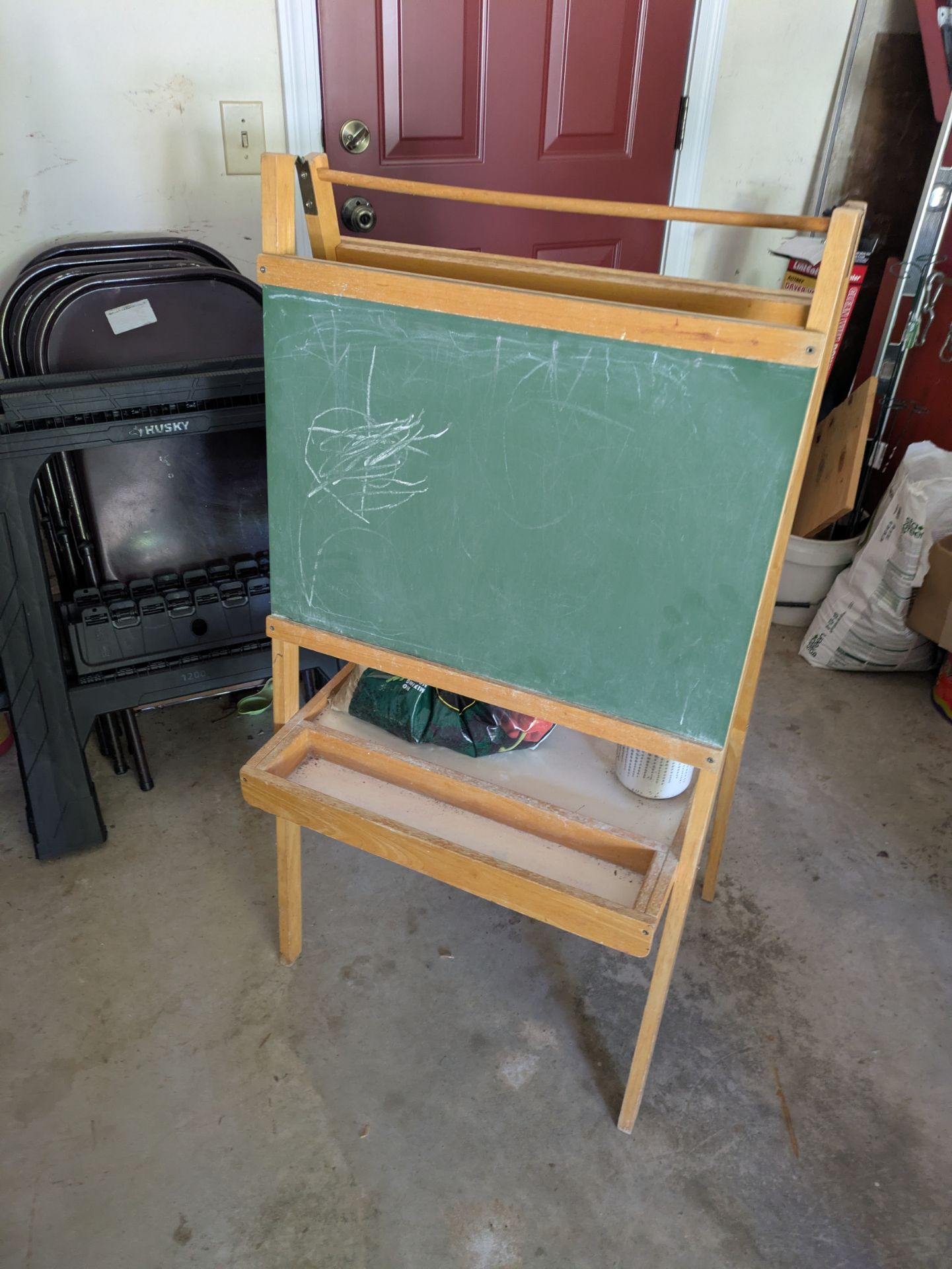 Wooden easel with a chalkboard and white board surface